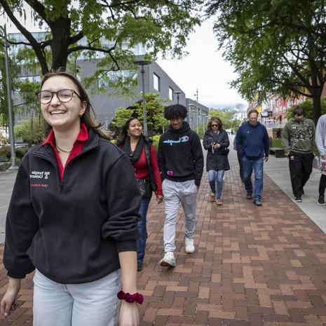 orientation leader giving a campus tour. 